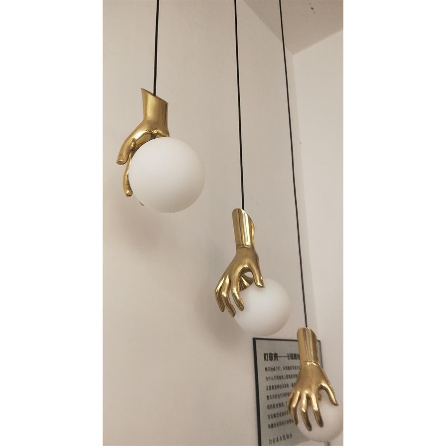 Avnorira Hand Holding Globe Brass Glass Pendant Light - Lamp Copper